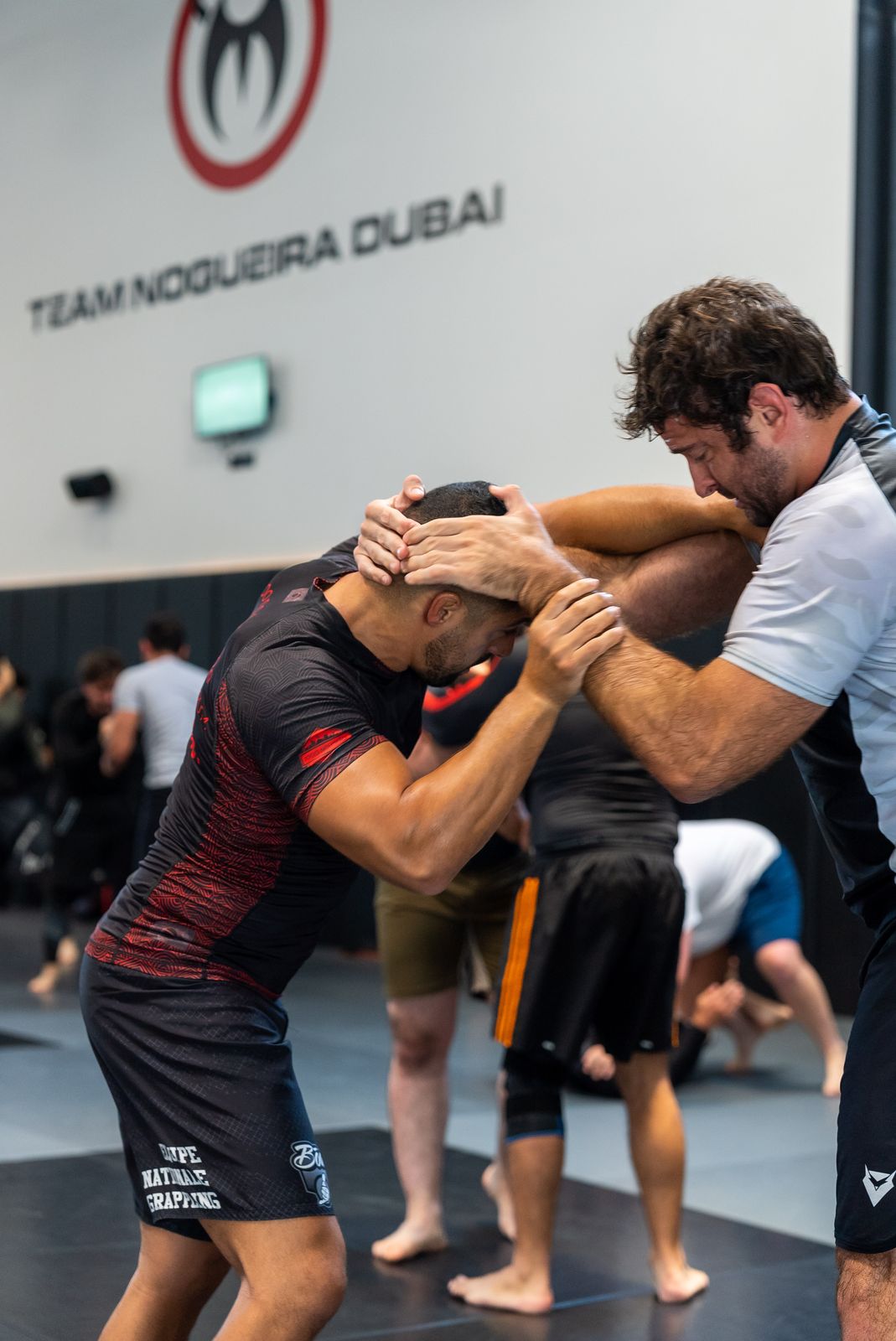 Athletes rolling during the Dubai open mat