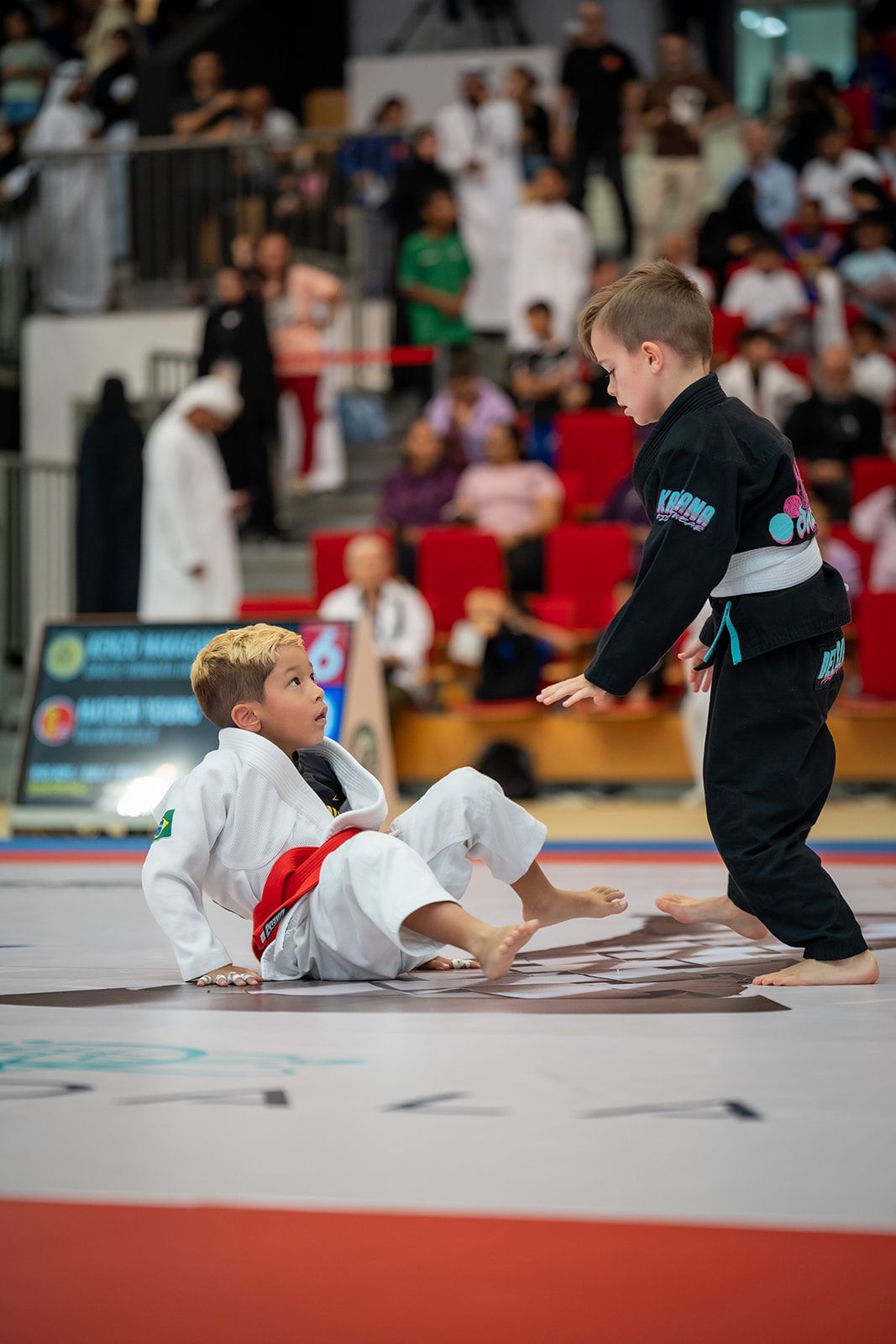 Jiu-Jitsu match in full action on the competition mats