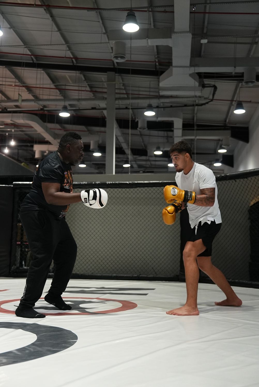 MMA fighter striking the pads with his coach